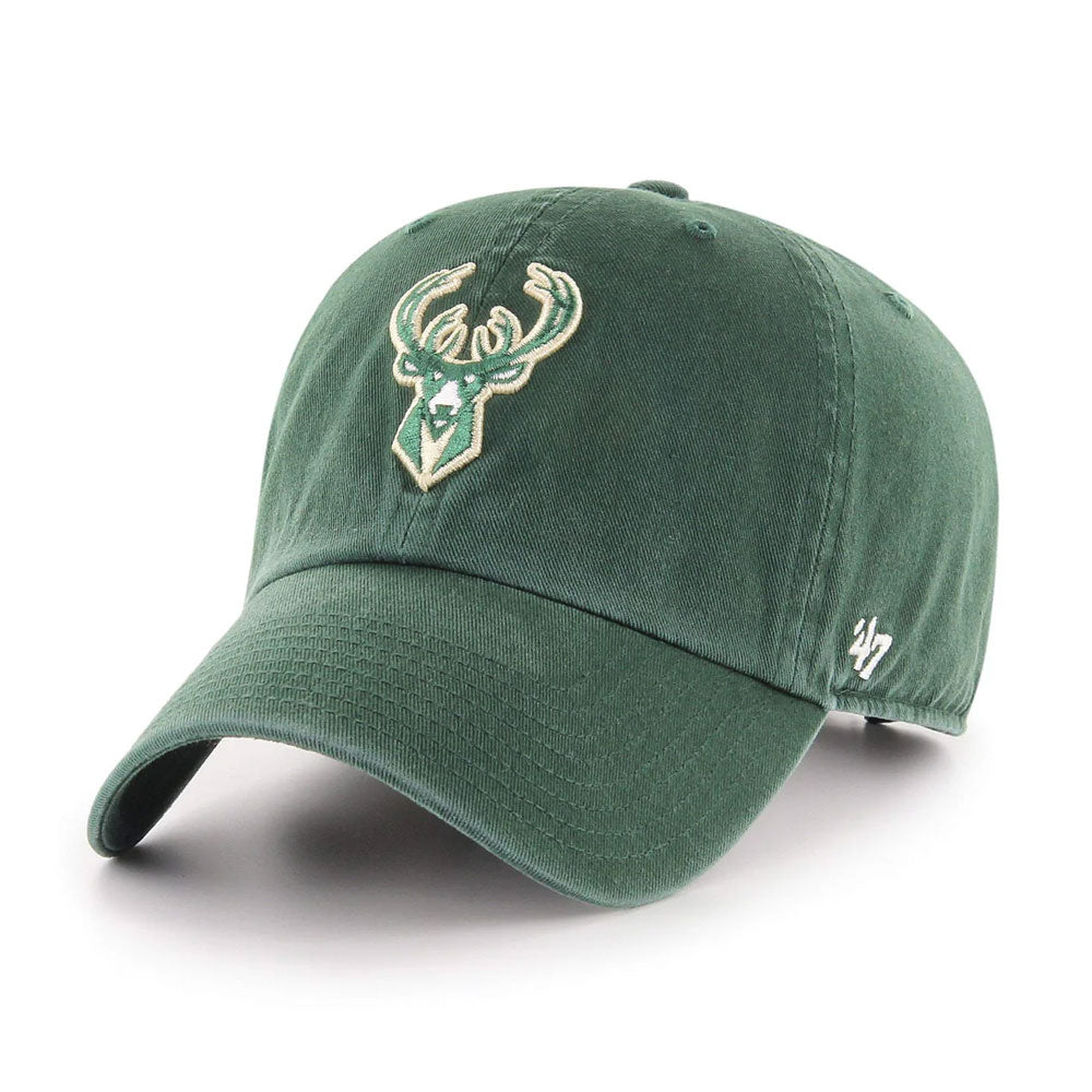 The Milwaukee Bucks 47 Clean Up Cap is a green cotton twill hat with a stylized deer head logo on the front, a white '47 logo on the side, and an adjustable strapback for comfort.