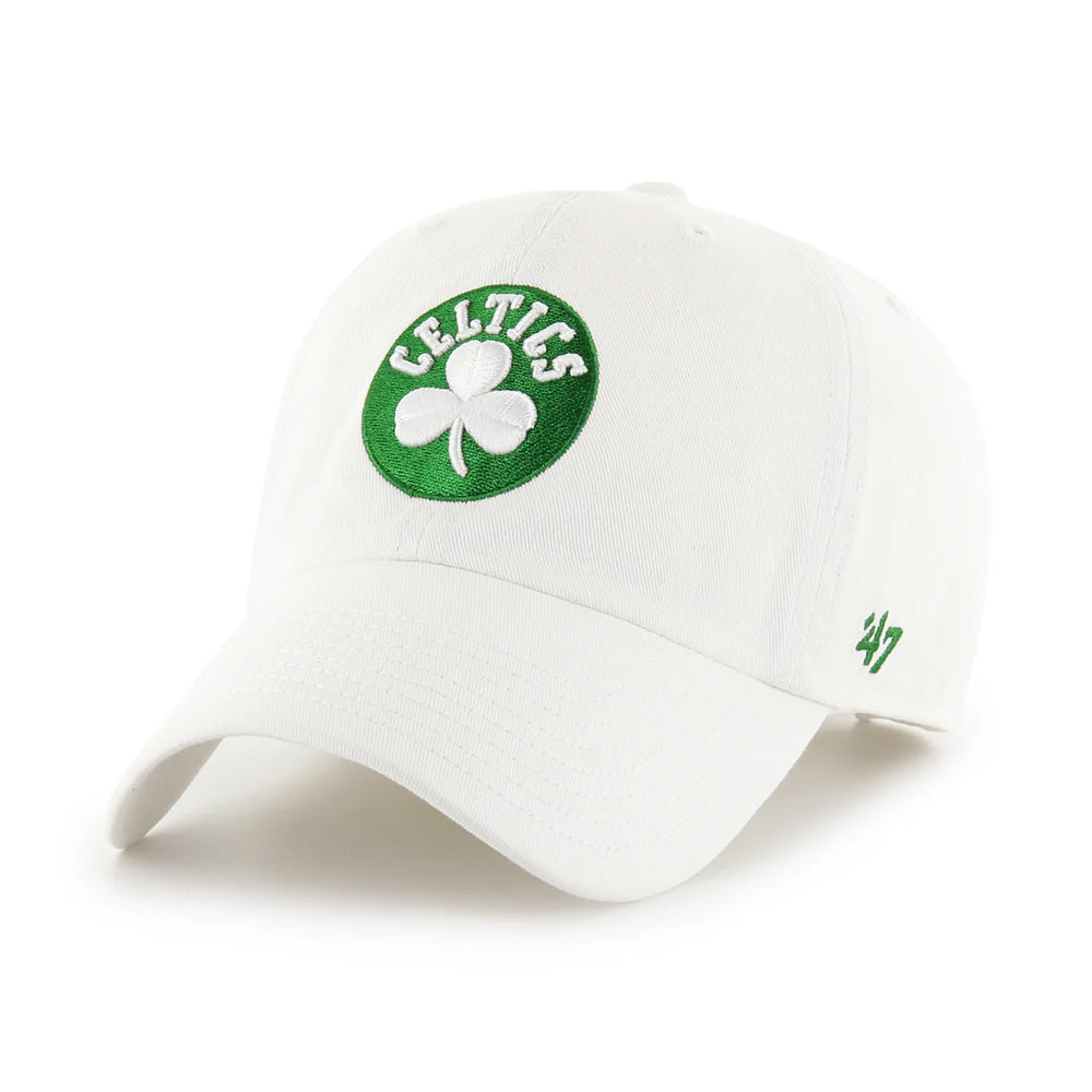 The Boston Celtics '47 Clean Up Cap is a white cotton twill hat with a green circle patch featuring a white shamrock and "Celtics" on the front, green 47 logo on the side, and an adjustable strapback for comfort.