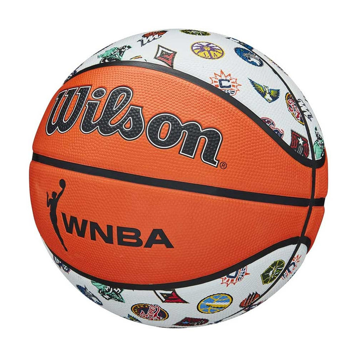 The Wilson WNBA All Team Basketball features an orange and white design with colorful WNBA team logos on the white panels, making it a vibrant and kid-friendly choice for young fans.