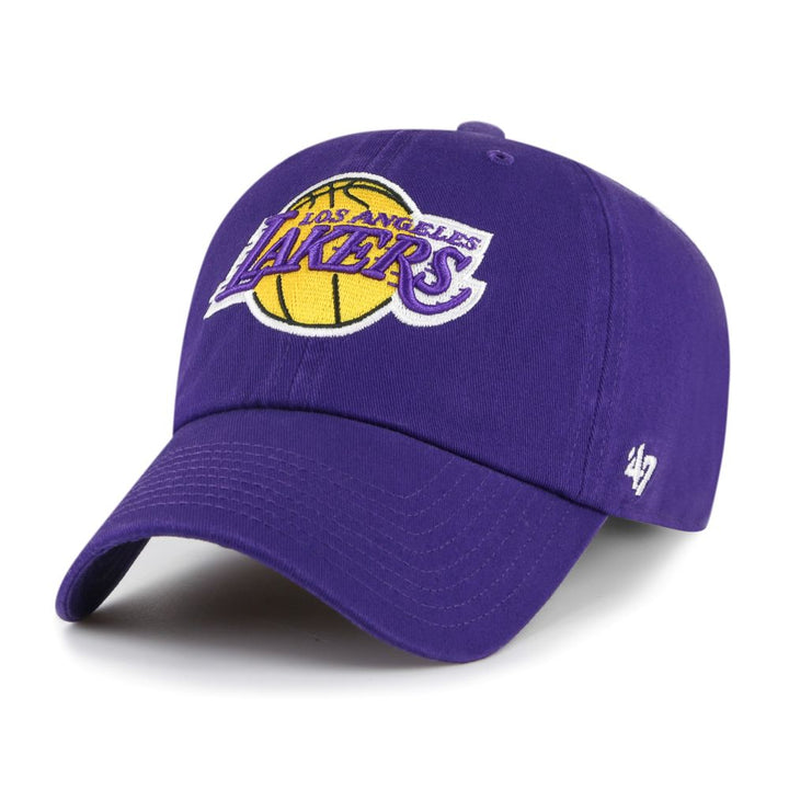 The Los Angeles Lakers '47 Clean Up Cap is a purple, garment-washed cotton twill hat featuring the team logo with a yellow basketball and white lettering on the front, an adjustable strapback, and the white '47 brand logo on the left.