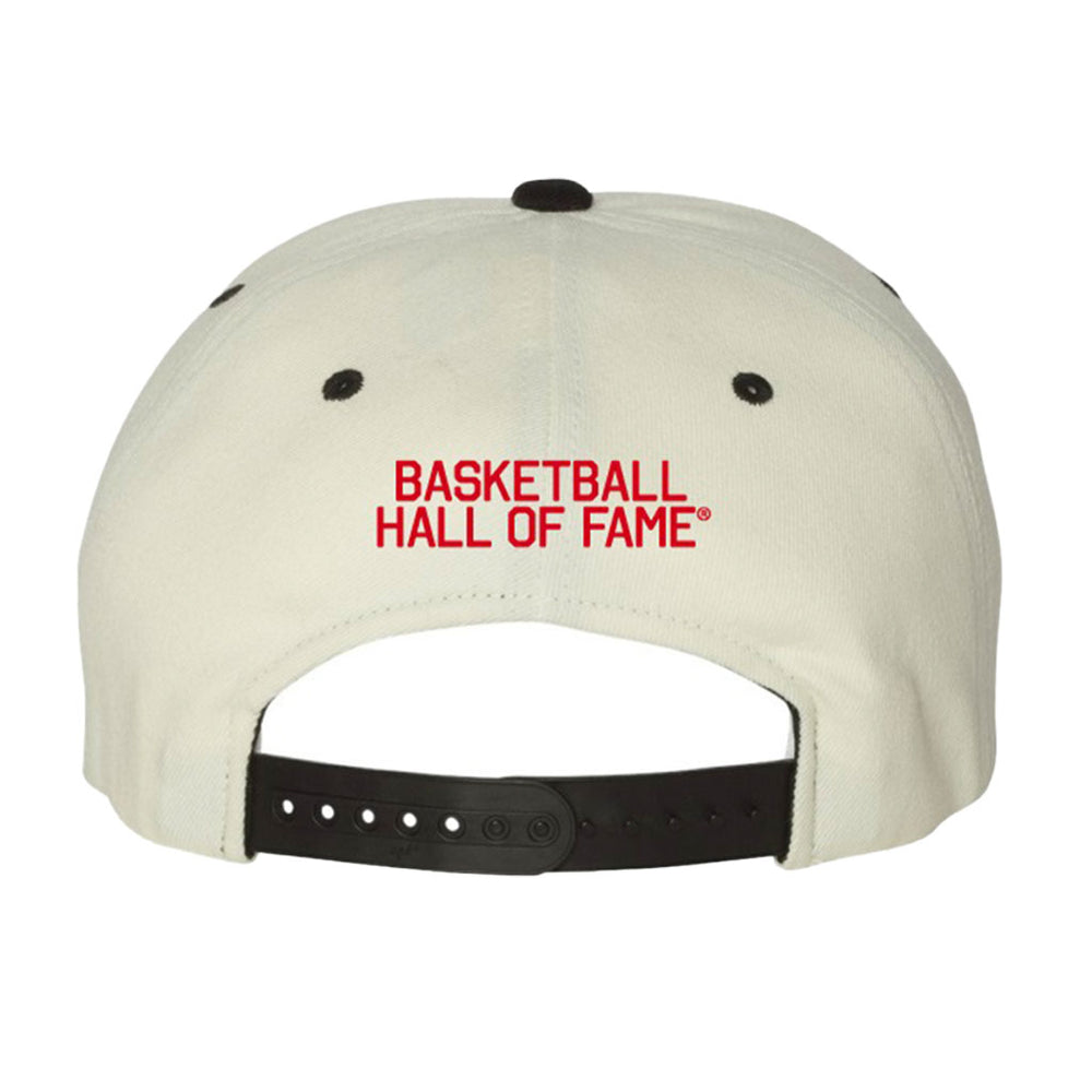 The Basketball Hall of Fame Buckets and Dimes Cap is a white snapback with red "BASKETBALL HALL OF FAME" text above a black adjustable strap—a limited edition hat perfect for basketball fans.