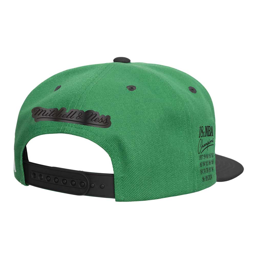 The Mitchell and Ness X Basketball Hall of Fame 18x NBA Champions Boston Celtics Cap features a green and black design, stitched logo above the adjustable strap, and NBA Champions years on the side—a must-have for true fans.