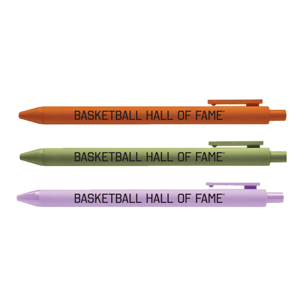 The Basketball Hall of Fame® Buckets and Dimes Pen Set includes three ballpoint pens in orange, green, and purple with "BASKETBALL HALL OF FAME" printed in black—ideal memorabilia for fans. Pens are arranged horizontally.