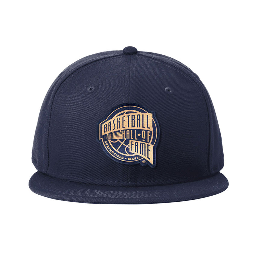Show your love for the game with the Basketball Hall of Fame® Building Patch Cap, a navy blue snapback featuring a flat brim and iconic logo patch—ideal for sports fans.