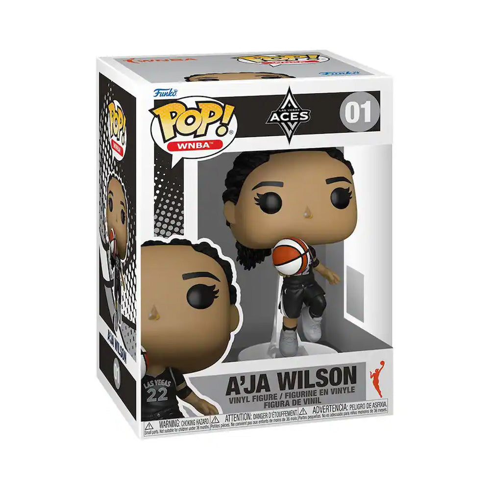 The Funko WNBA Las Vegas Aces POP! A'ja Wilson vinyl figure features her holding a basketball in her black “22” jersey with WNBA branding, displayed in its box—a must-have for any Funko Pop! collection.