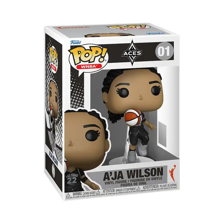 The Funko WNBA Las Vegas Aces POP! A'ja Wilson vinyl figure features her holding a basketball in her black “22” jersey with WNBA branding, displayed in its box—a must-have for any Funko Pop! collection.