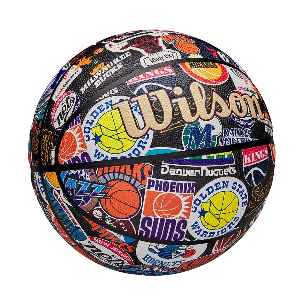 The Wilson NBA All Team Retro Basketball features colorful NBA team logos and names, including the Warriors, Suns, Jazz, Nuggets, and Mavericks, for a vibrant retro look across its entire surface.