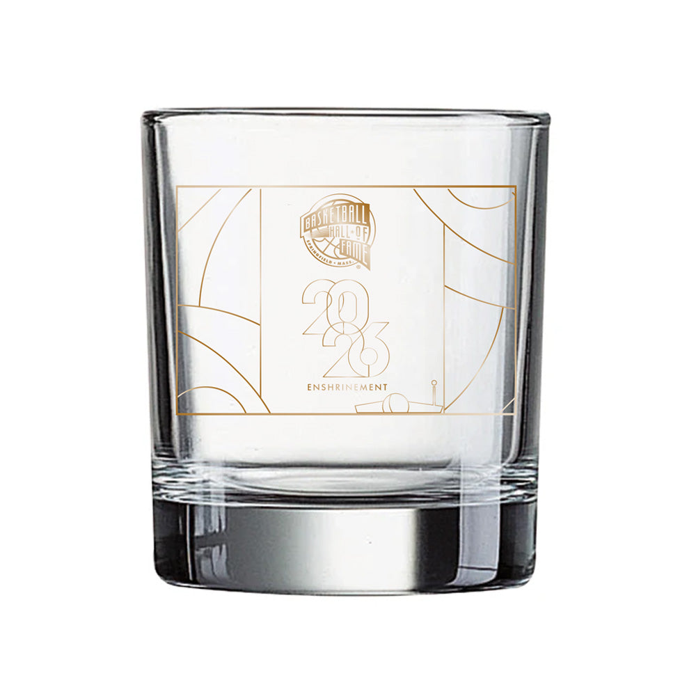 Celebrate the historic 2026 Enshrinement with the Basketball Hall of Fame® 2026 Enshrinement Rocks Glass, featuring a clear design accented by geometric lines and an elegant gold logo on the front—perfect for fans and collectors seeking to commemorate this special basketball milestone.