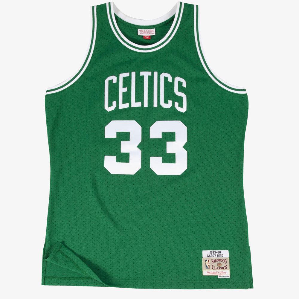 The NBA Mitchell & Ness Boston Celtics Road Bird '85 Jersey is green with white trim, features "Celtics" and the number 33 on the front, and has a stitched patch with Larry Bird’s player details at the bottom.