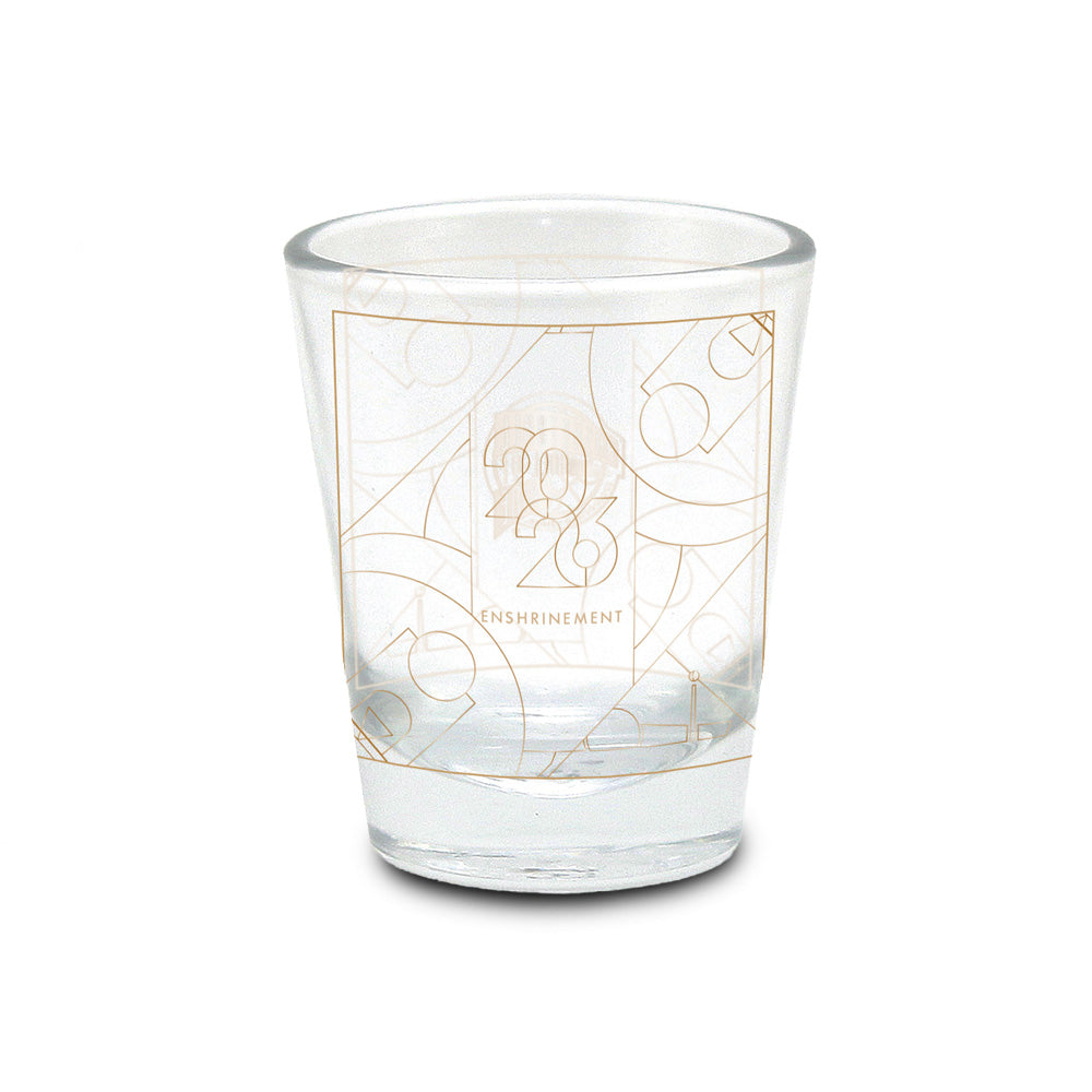 Showcase your love for the game with the Basketball Hall of Fame® 2026 Enshrinement Shot Glass. This clear glass shot glass features a striking gold geometric design and "2026 Enshrinement" printed on the front. Overlapping basketball motifs in the background create a unique and eye-catching look, making it an excellent addition to any basketball collectibles display. Celebrate basketball history with this must-have keepsake, perfect for fans and collectors alike.