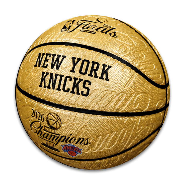 The 2026 NBA Champions New York Knicks Limited-Edition Basketball features gold color, Knicks logo, textured surface, signatures, and text: NBA Finals, NEW YORK KNICKS, and 2026 NBA Champions.