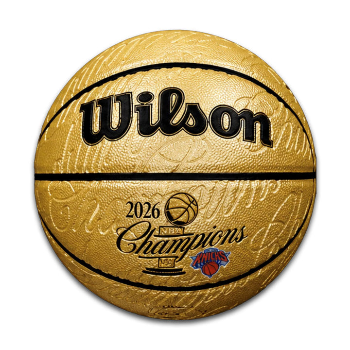 The 2026 NBA Champions New York Knicks Limited-Edition Basketball features a gold finish, Wilson branding, "2026 NBA Champions," and the Knicks logo printed on it, displayed against a white background.